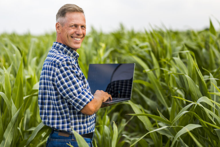 man with laptop looking camera